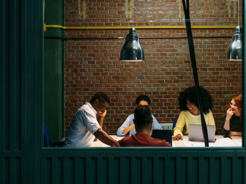 Business Group In A Meeting Room In The Office Team at work. Group of business people working and communicating together in creative office.